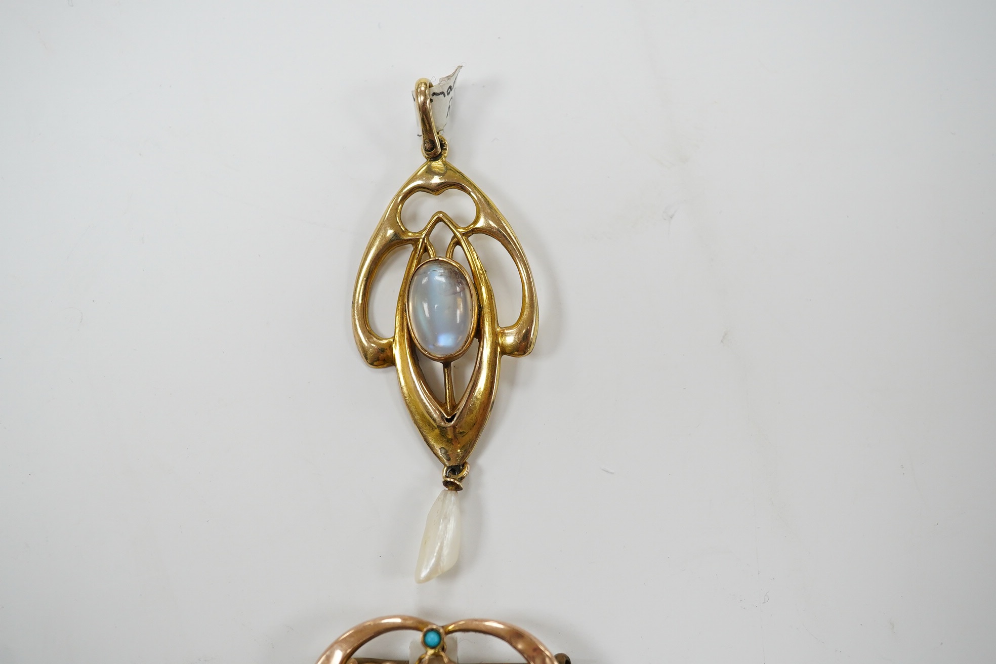 An Edwardian Art Nouveau 9ct gold, cabochon moonstone and baroque pearl drop set pendant, 56mm, together with a similar 9ct gold, baroque pearl and turquoise set drop brooch, 26mm, gross weight 4.5 grams. Condition - fai